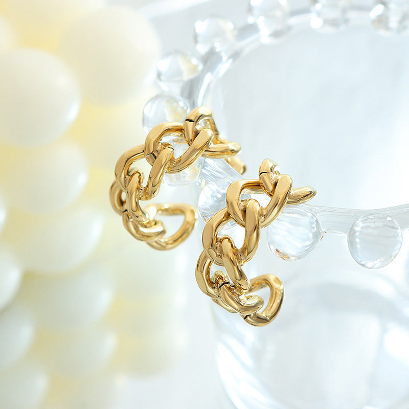 Cold wind niche fashion twist hollow C-shaped earrings titanium steel plated 18K gold stud earrings F322