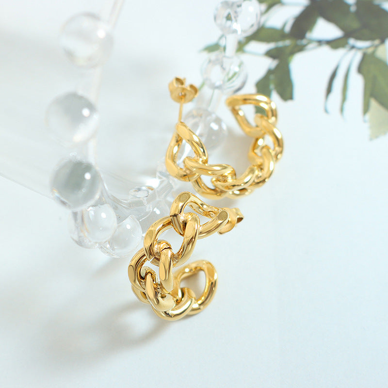 Cold wind niche fashion twist hollow C-shaped earrings titanium steel plated 18K gold stud earrings F322