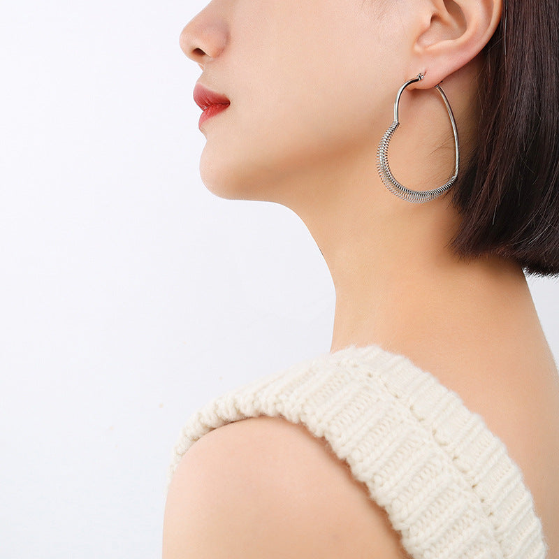 Retro style temperament spring peach heart earrings titanium steel plated irregular ear jewelry F259