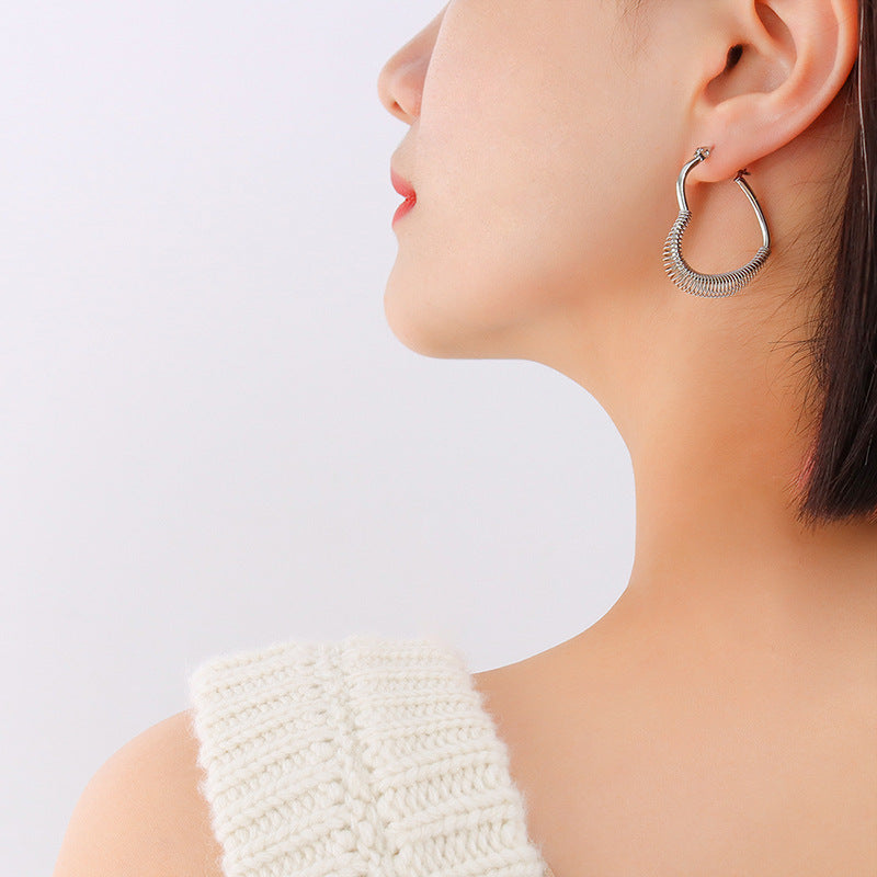 Retro style temperament spring peach heart earrings titanium steel plated irregular ear jewelry F259