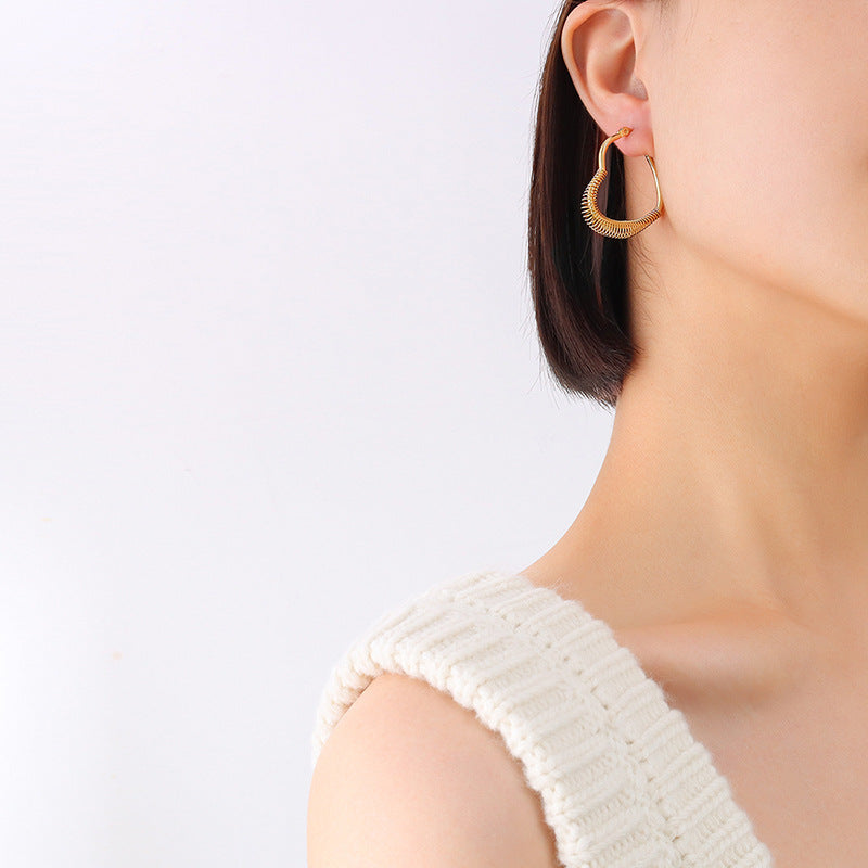 Retro style temperament spring peach heart earrings titanium steel plated irregular ear jewelry F259
