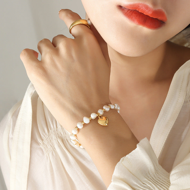 Personality temperament Freshwater pearl splicing steel ball bracelet women's fashion creative design peach heart pendant bracelet