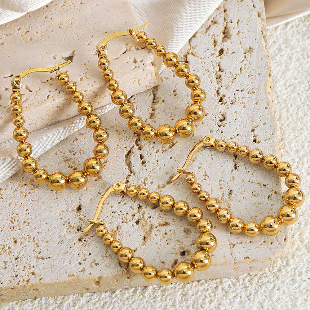 Creative sense of high-end luxury personality temperament titanium steel 18K gold bead earrings metal wind earrings women