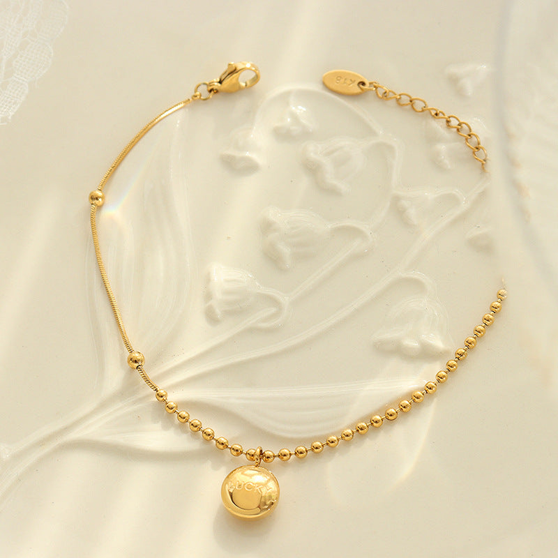 Fashion commuter letter engraving round brand pendant bracelet niche design titanium steel gold-plated round bead splicing